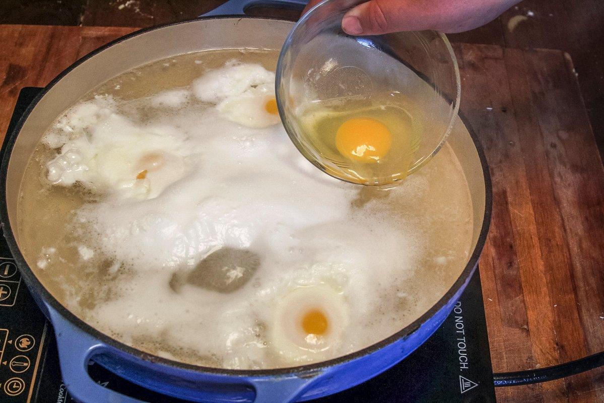 Poach the eggs at a heavy simmer/light boil in water with a bit of white vinegar.