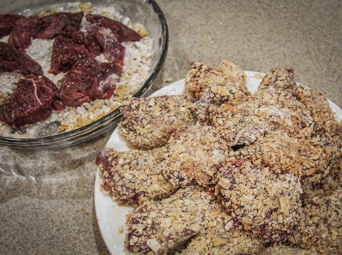 Coat the backstrap steaks in the flour/onion mixture.