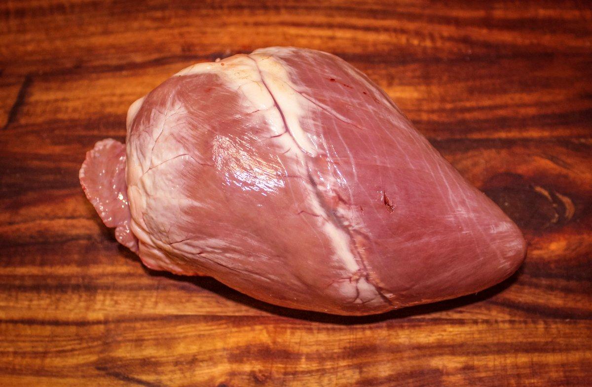 Trim away all fat from the exterior of the heart, then cut it open to lay flat.