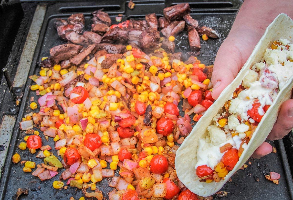 Sear the taco ingredients on the hot griddle, then serve on warm flour tortillas. 