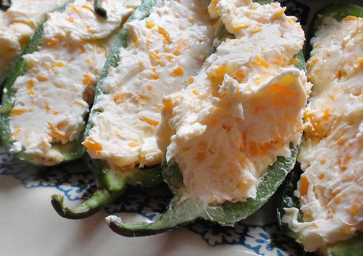 Stuff the peppers with the shredded cheese and cream cheese mixture.