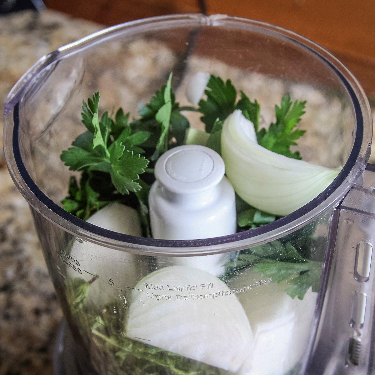 Add the fresh parsley, mint and onions to the food processor. 