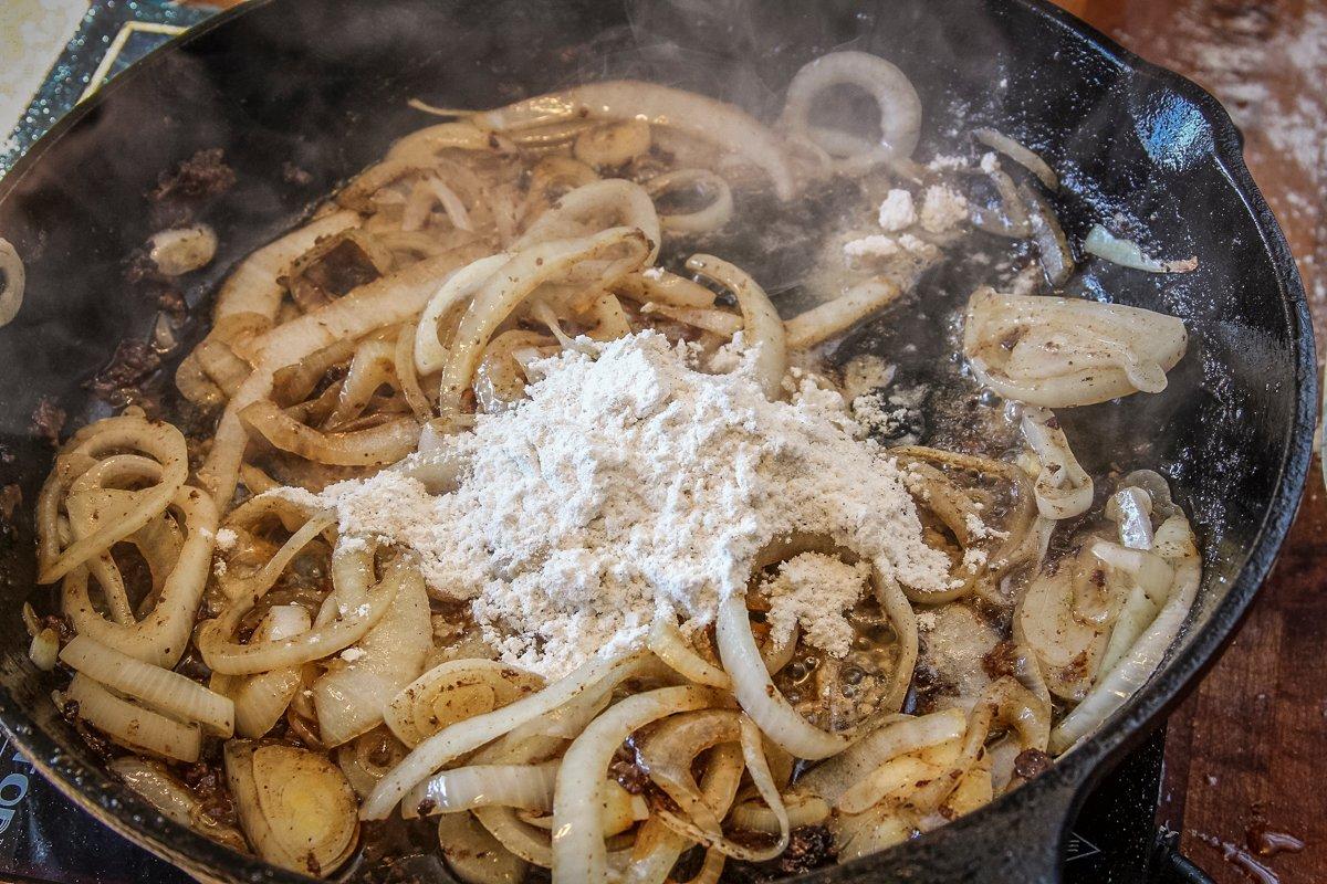 Add flour to the softened onions and cook until it takes on a deep tan color.