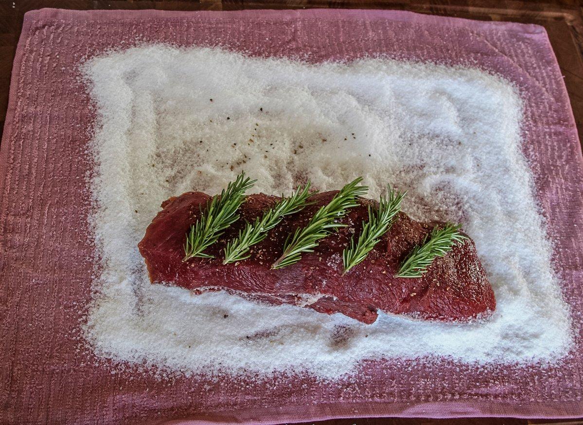 Place the backstrap on a layer of salt on the wine=soaked towel.