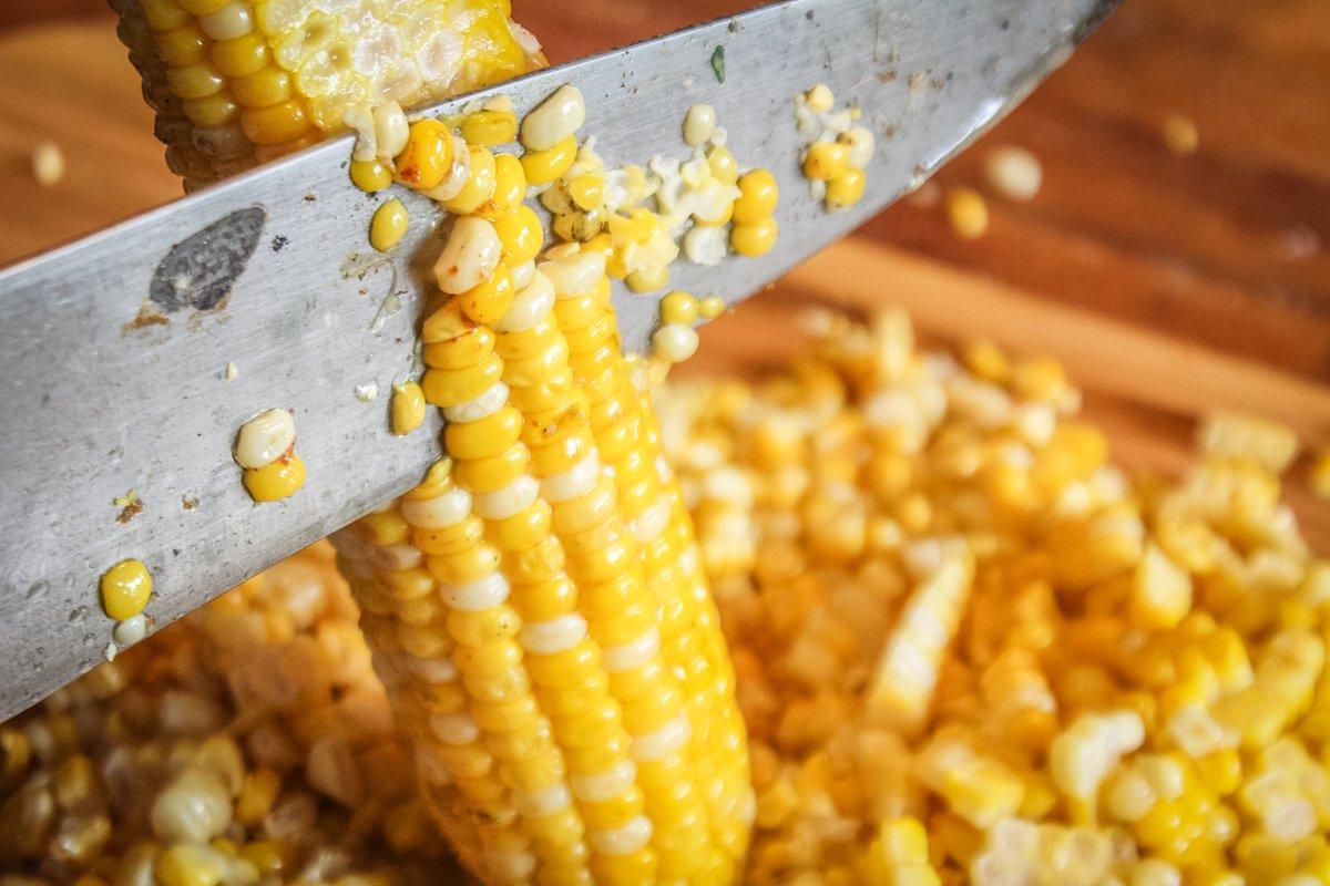 After grilling, slice the corn from the cob.