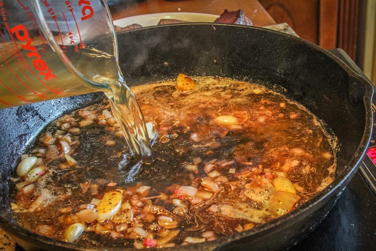 After searing the steaks, saute the shallots and deglaze the pan with stock.