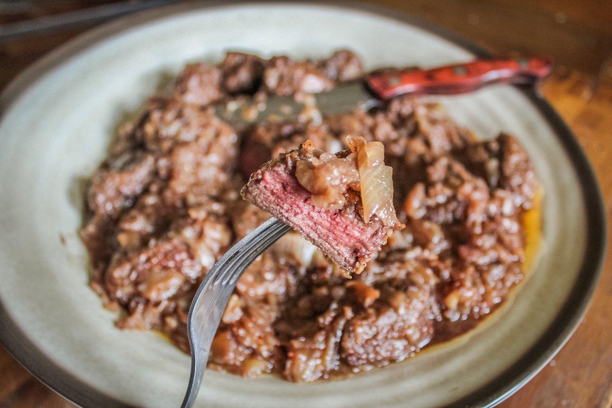 Simmer the backstrap in the onions until they are medium-rare. 