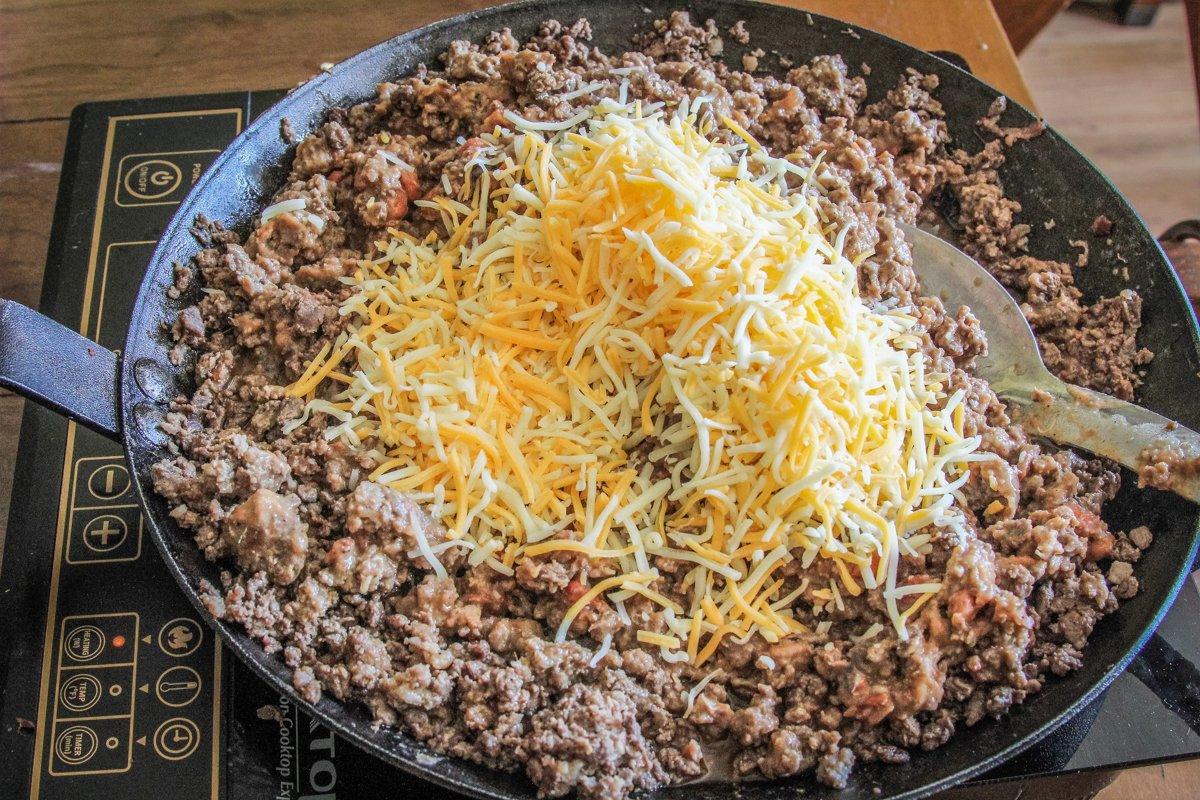 Brown the venison and sausage, then blend in the cheese.
