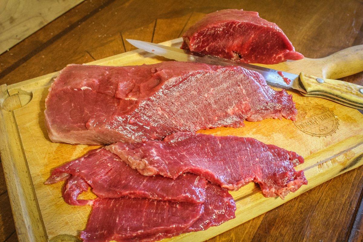 Slice the steak against the grain into long, thin strips.