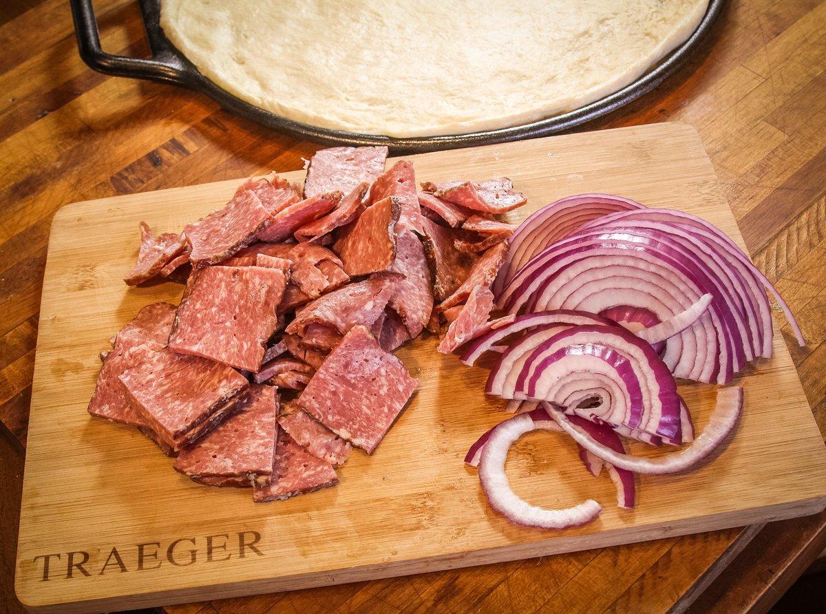 Slice the venison bacon and red onion.