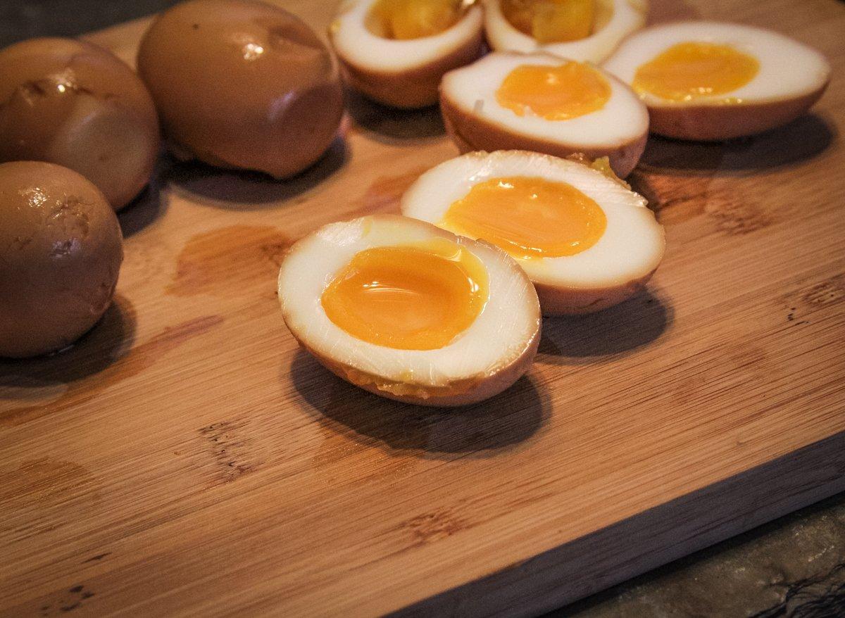 The marinated eggs should have a soft, slightly runny, yolk.