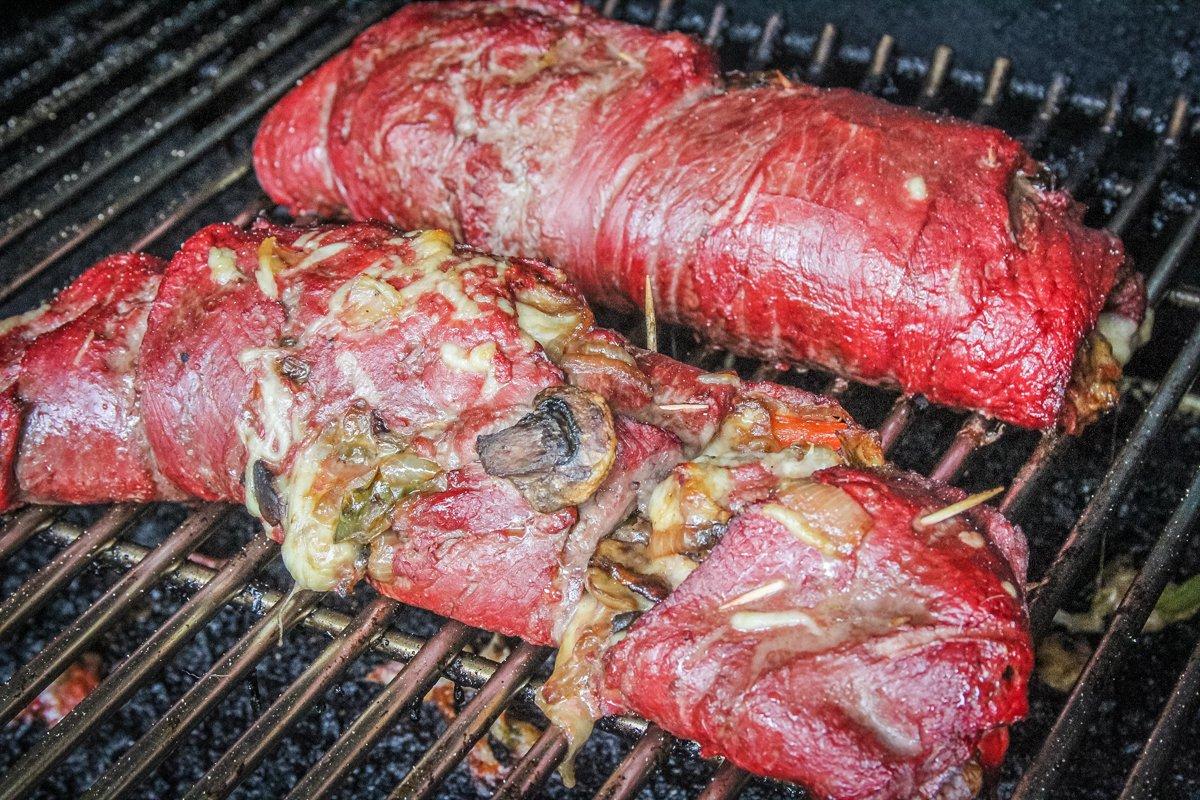 Roll the meat, pin it closed with toothpicks, and grill on the Traeger.