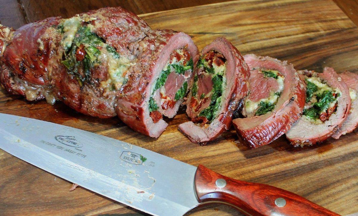 Roll the steak and tie it with butcher's twine to hold the stuffing ingredients in while the meat grills.