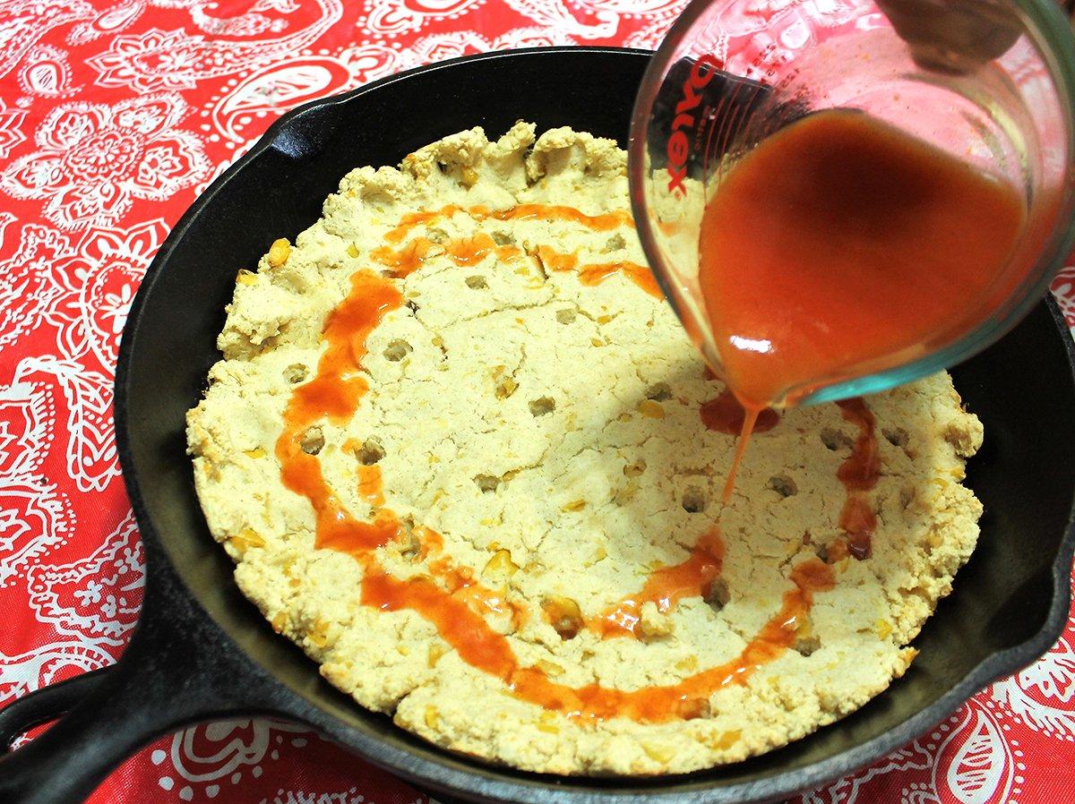 Poking holes in the baked crust before pouring on the enchilada sauce gives it an almost steamed texture when finished.