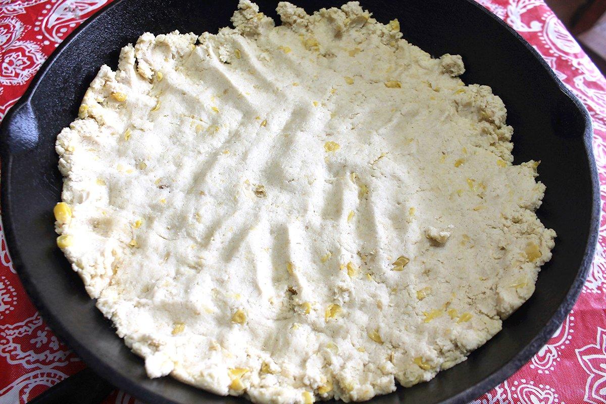 Press the stiff dough mixture into the bottom of a well-seasoned cast iron skillet or a Pyrex dish.