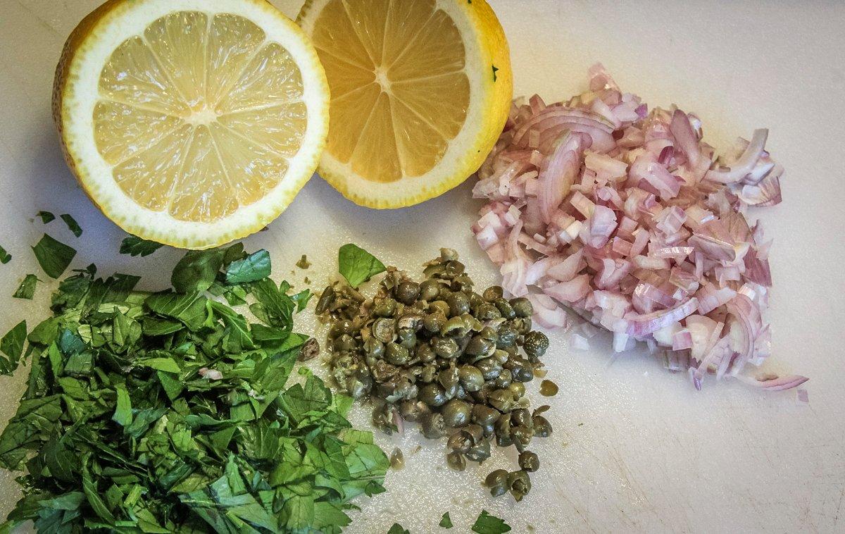 Start the seasoning sauce with fresh lemon juice and diced herbs, shallots and capers.