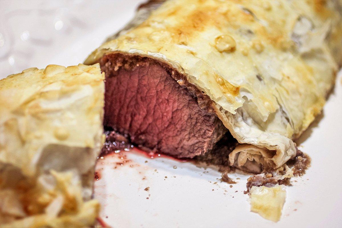 Wrap the backstrap in the puff pastry then brush it with egg wash before baking.