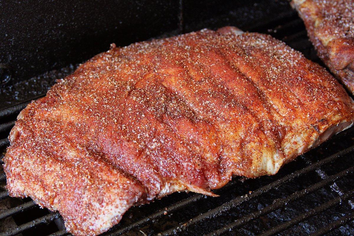 Coat the ribs with the rub mixture, then smoke at 250 degrees for two hours.