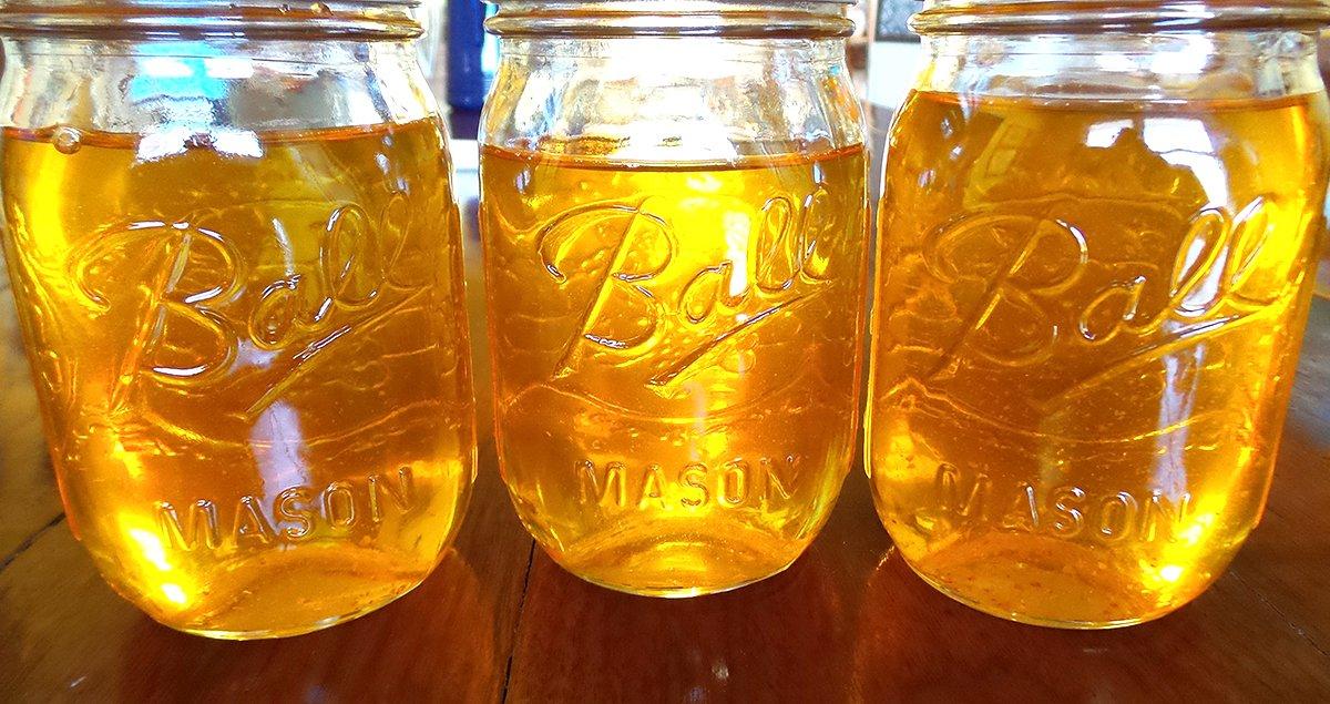 Pour the warm fat into jars for storage.
