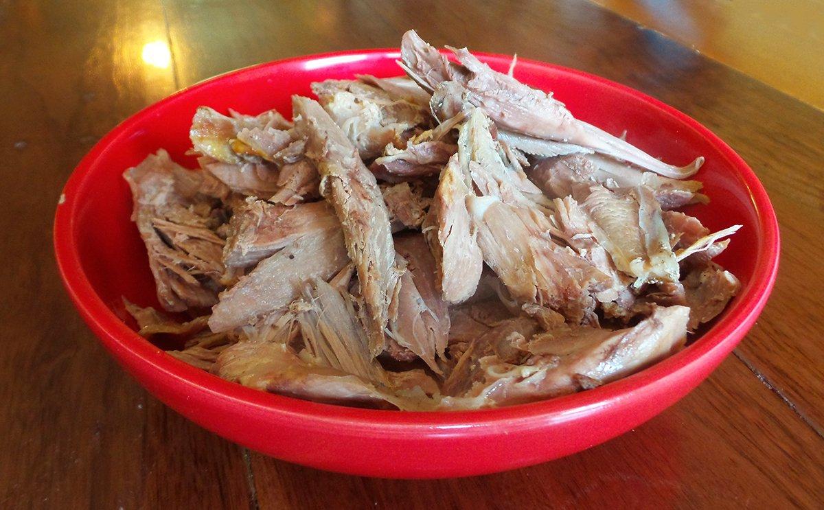 Pick the dark meat from the turkey bones.