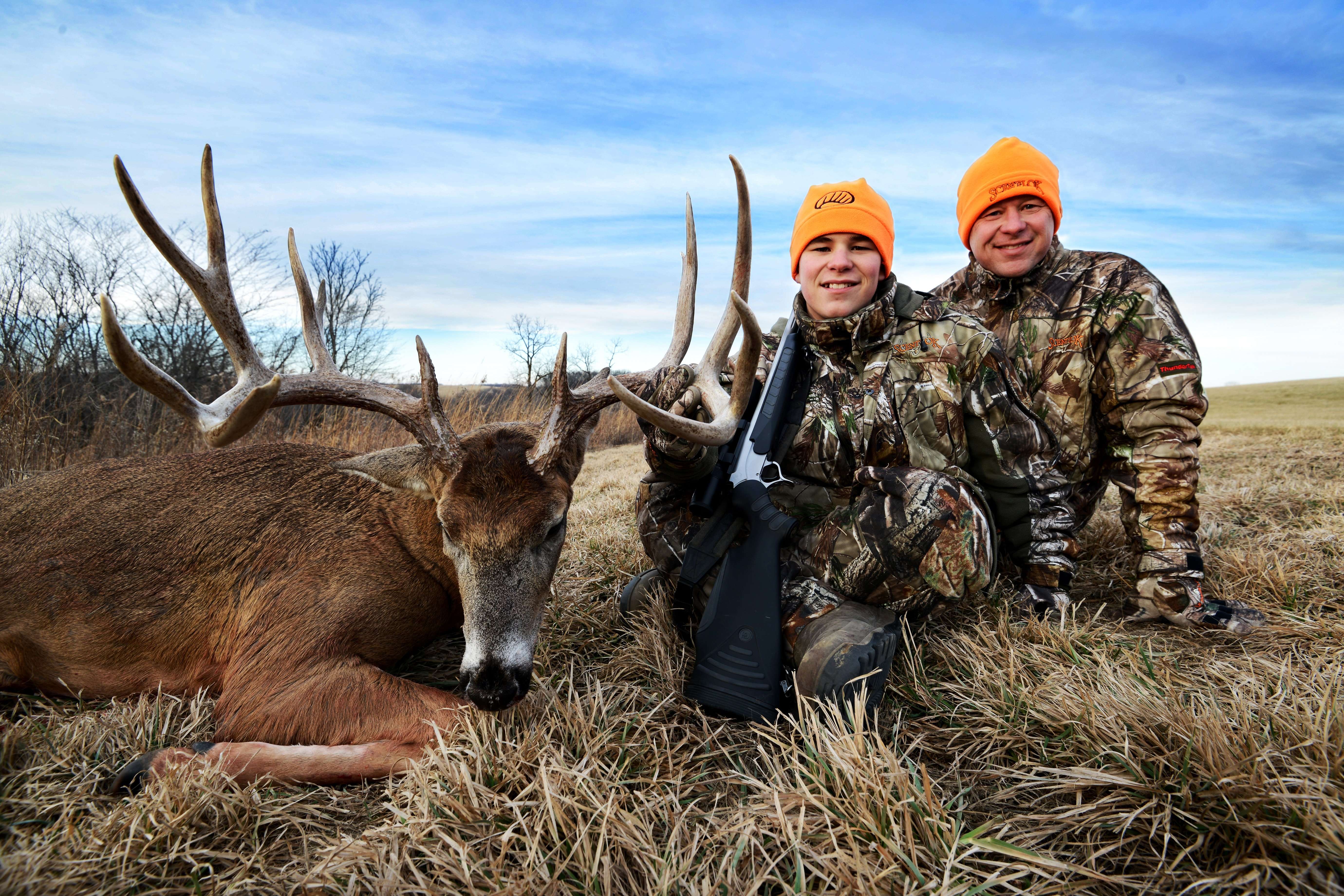 Parker Baugh with his father, Rich, and his 182-inch Iowa Bruiser.