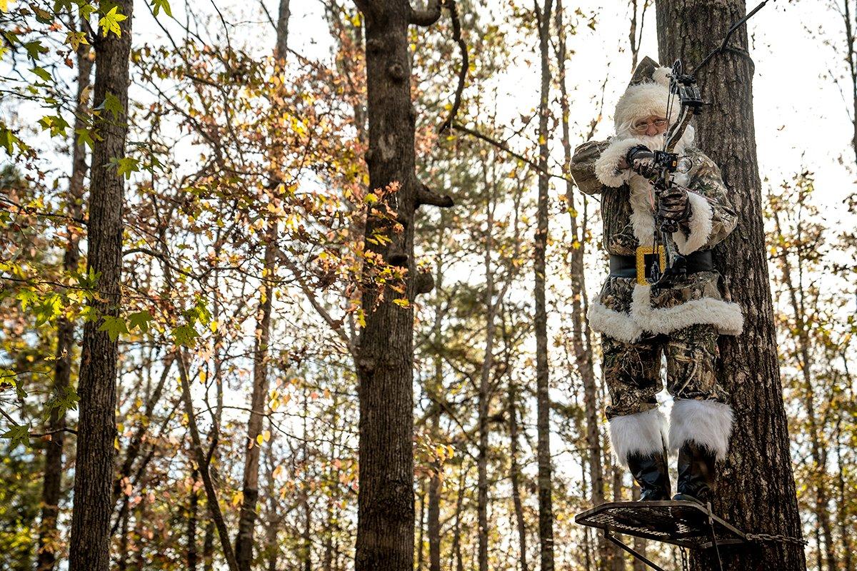 Santa bends at the waist and waits for the perfect shot. 