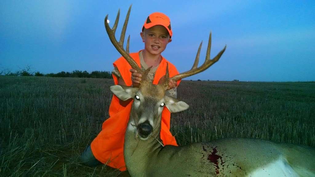 Clay Shively, 8, with the 9-pointer he killed earlier this year.