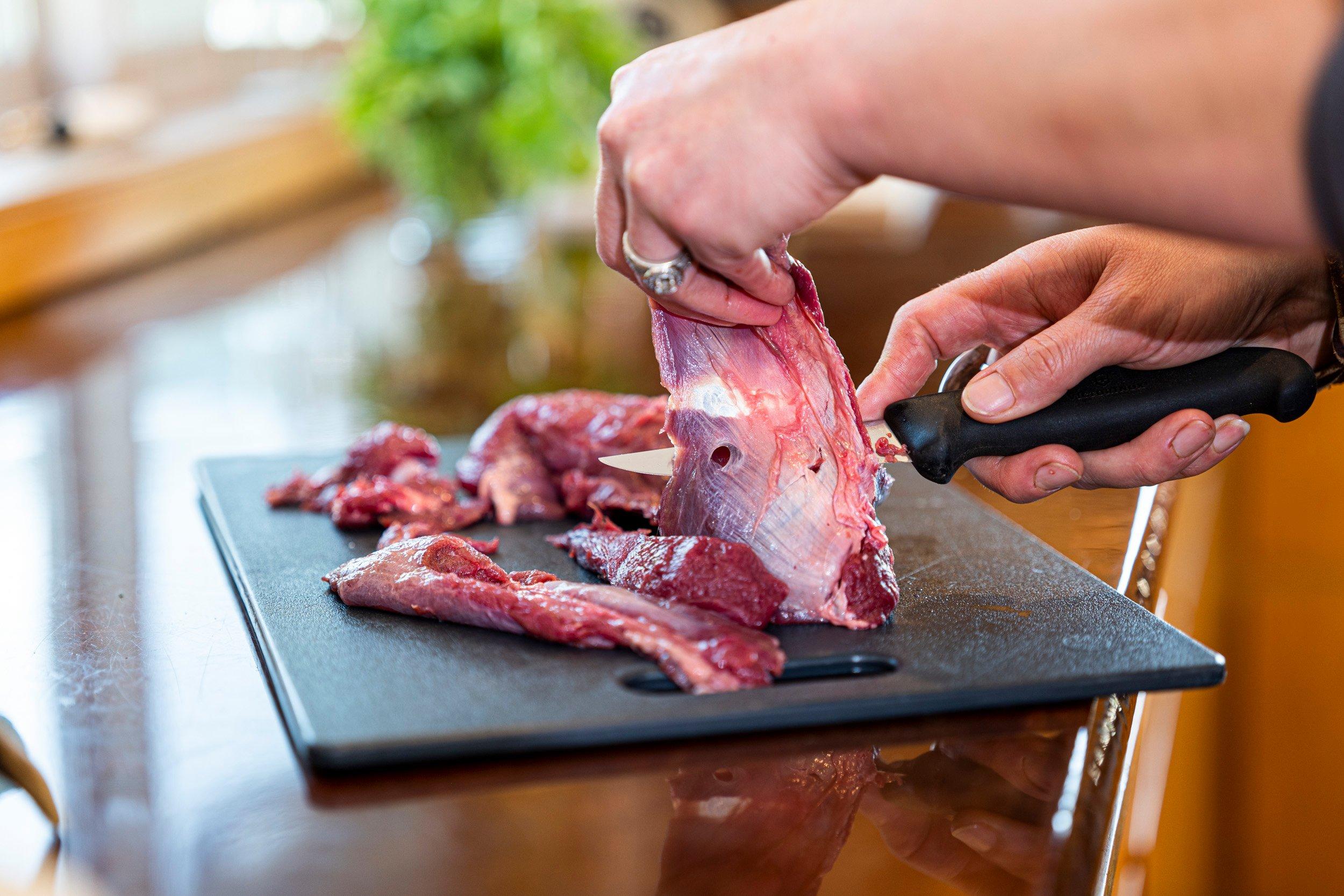Trim away fat and connective tissue from bear meat before slicing into thin strips. Image by GritMedia
