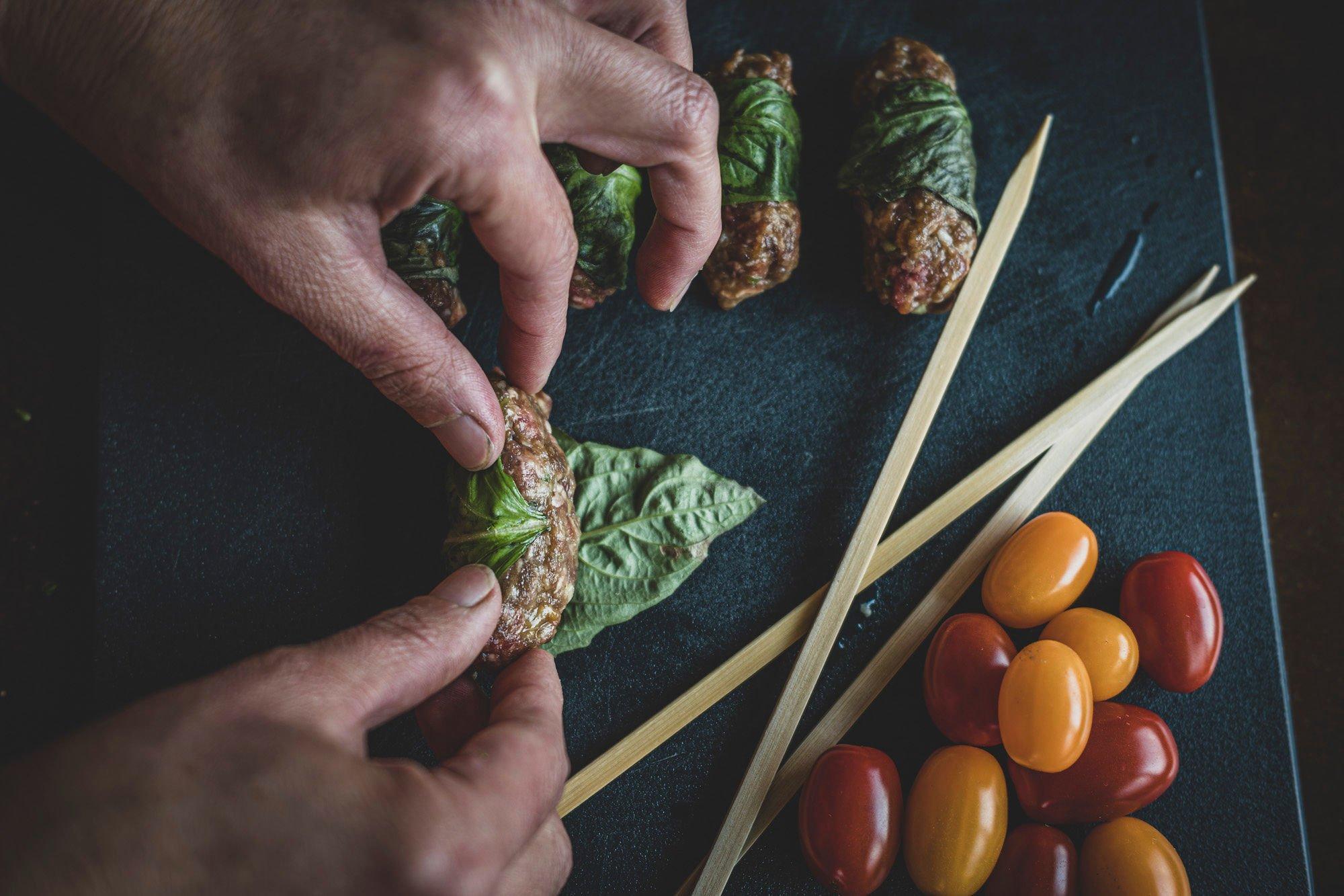 Roll the meat mixture in a mint or basil leaf. Image by Grit Media