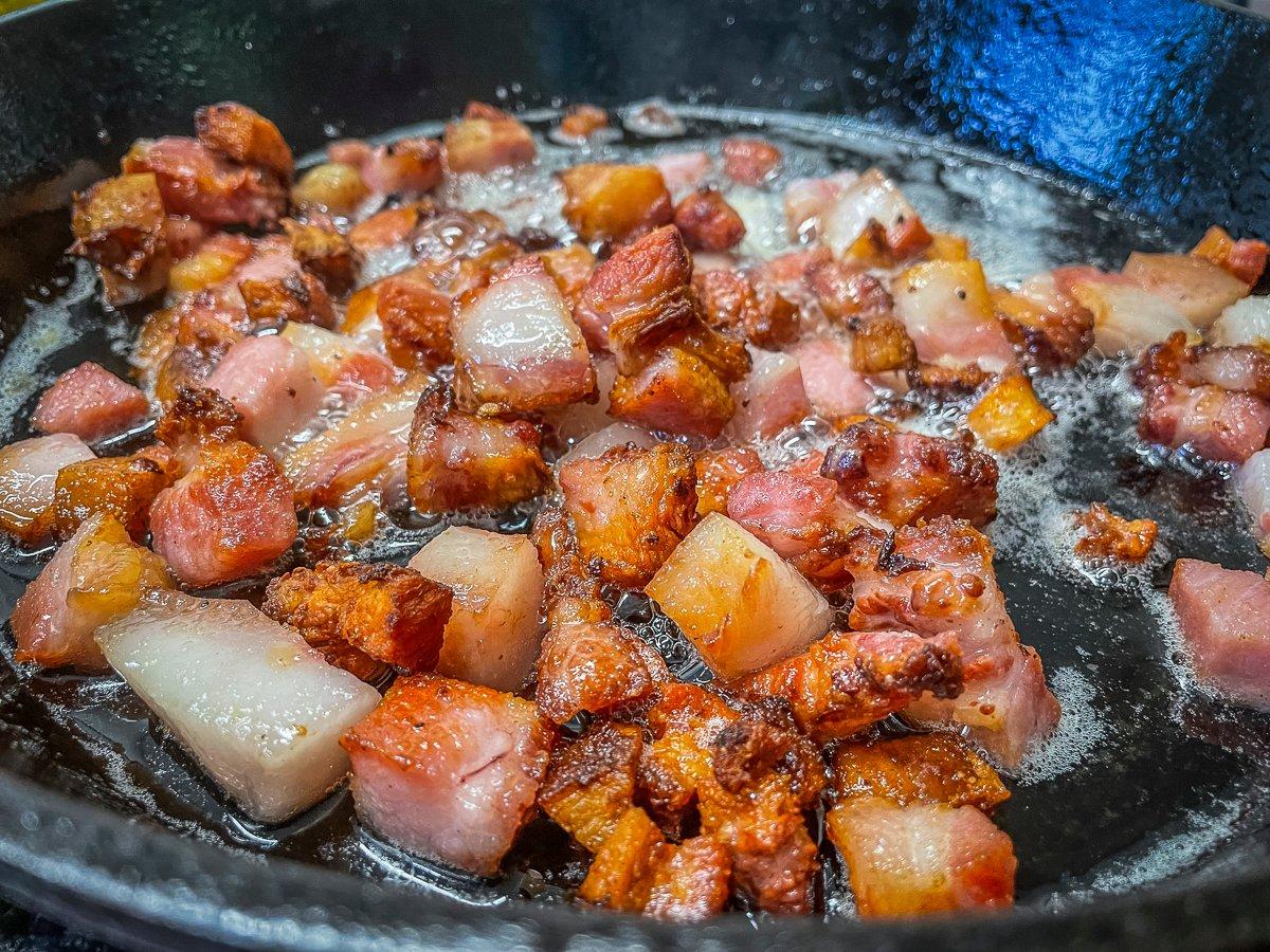 Render the thick-cut bacon until it starts to crisp, then cook the mushrooms and onion in the bacon grease.