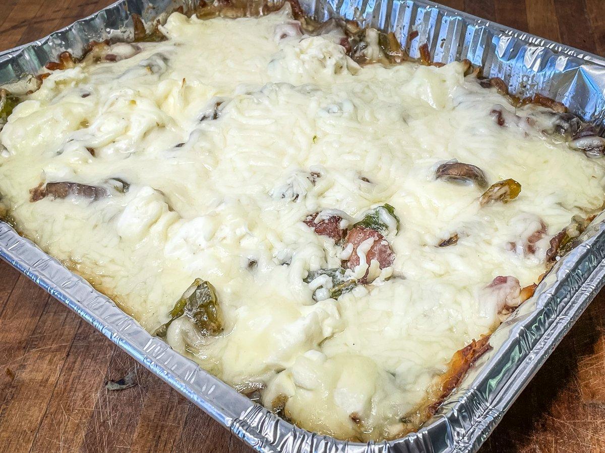 Cover the casserole with cheese, then grill until done.