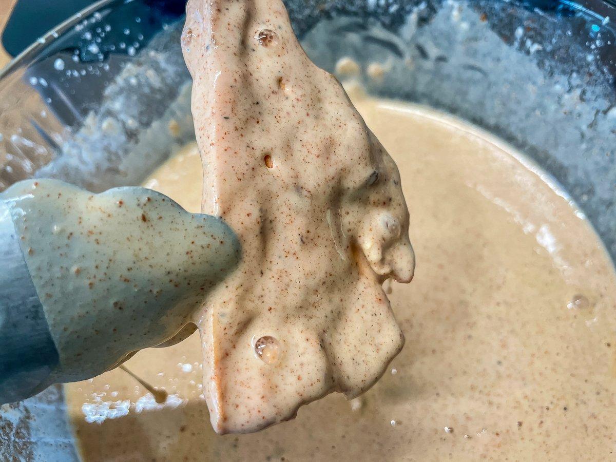 Dip the mushrooms into batter, letting the excess drip back into the bowl.