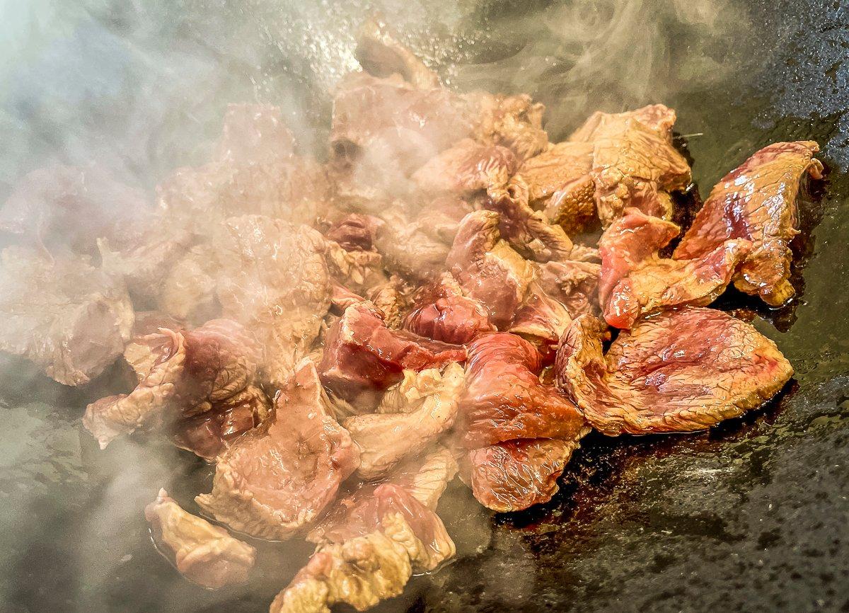 Stir-fry the venison hot and fast until it's browned but not overdone.