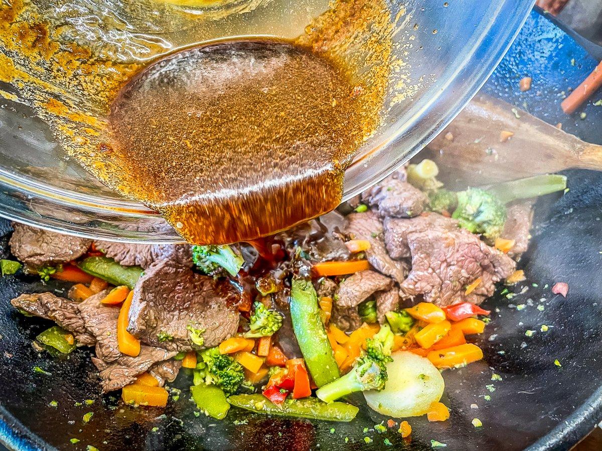 Return the meat to the wok with the cooked vegetables, then pour over the sauce.