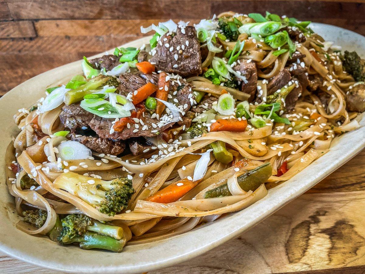 Slicing the venison across the grain into thin strips, then flash stir-frying in a hot wok makes it tender.