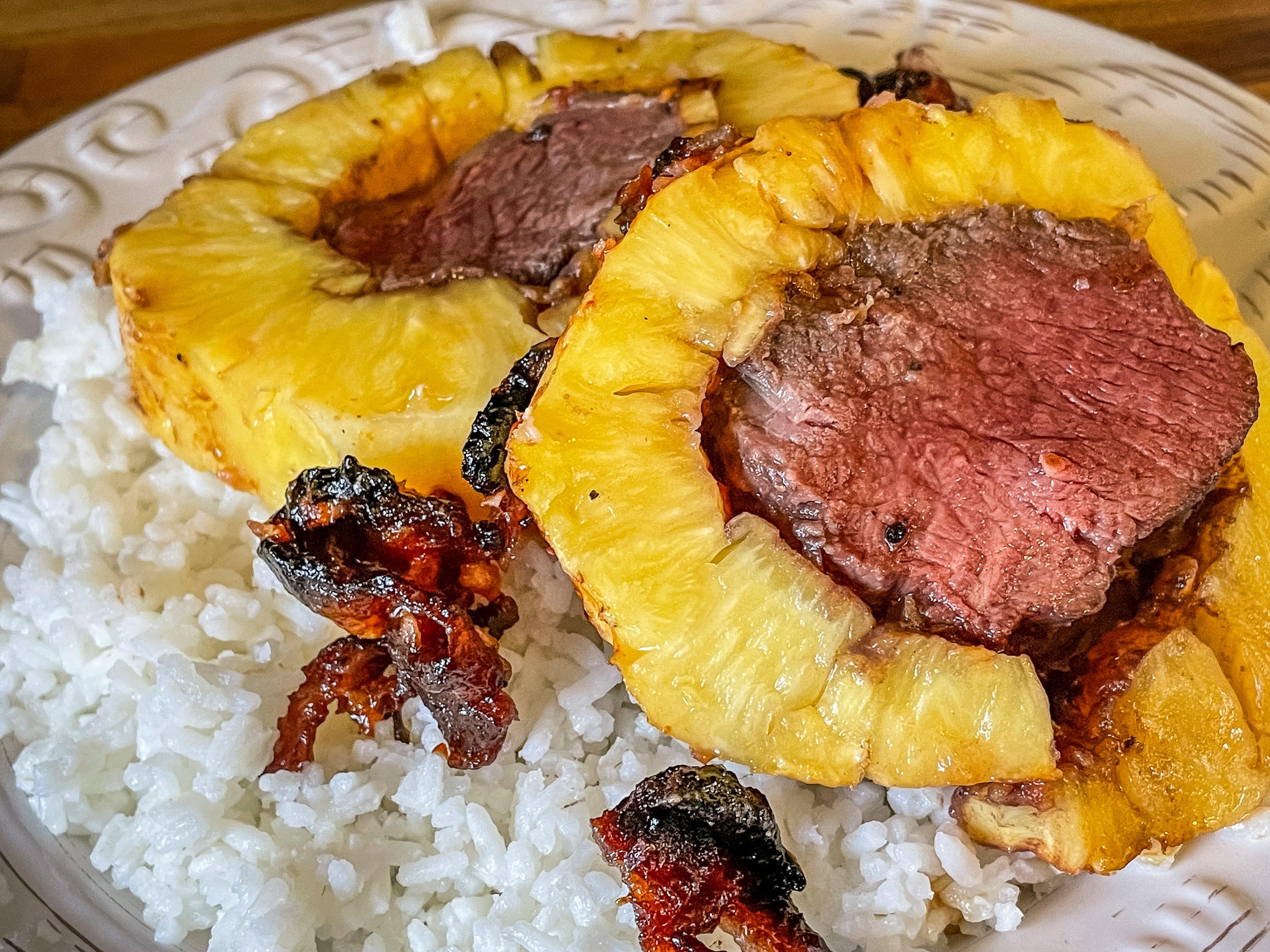Serve the backstrap and pineapple over rice for a full meal.