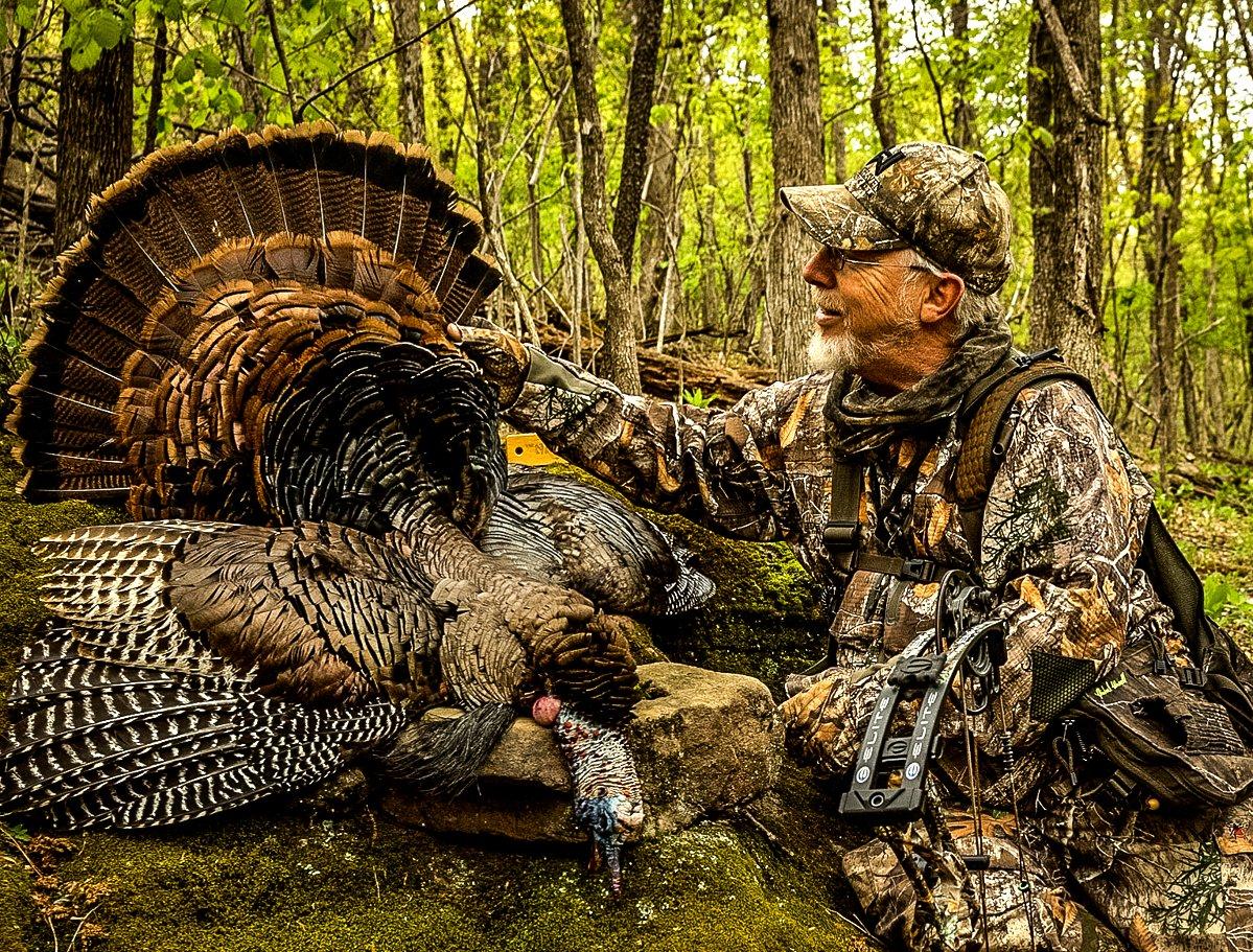Getting a gobbler with a bow is always a challenge. Realtree pro-staffer Phillip Vanderpool admires a nice tom. Image by Brandon Godin