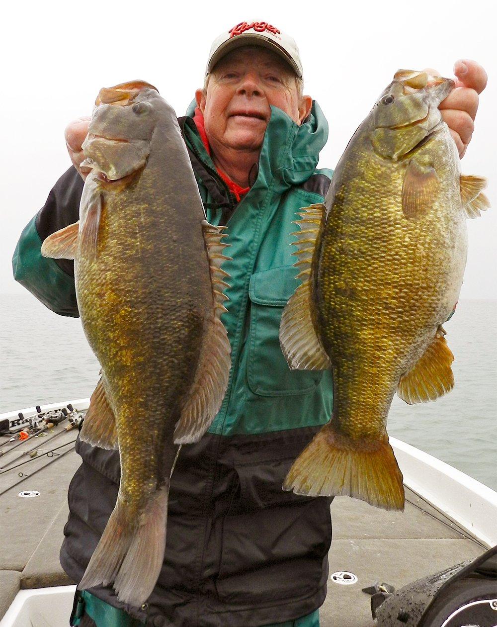 Great Lakes legend Steve Clapper holds up a pair of big bronzebacks. Image by Joe Balog