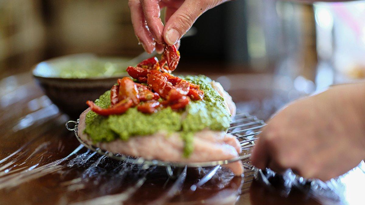 Top the turkey breast with pesto and sun dried tomatoes.