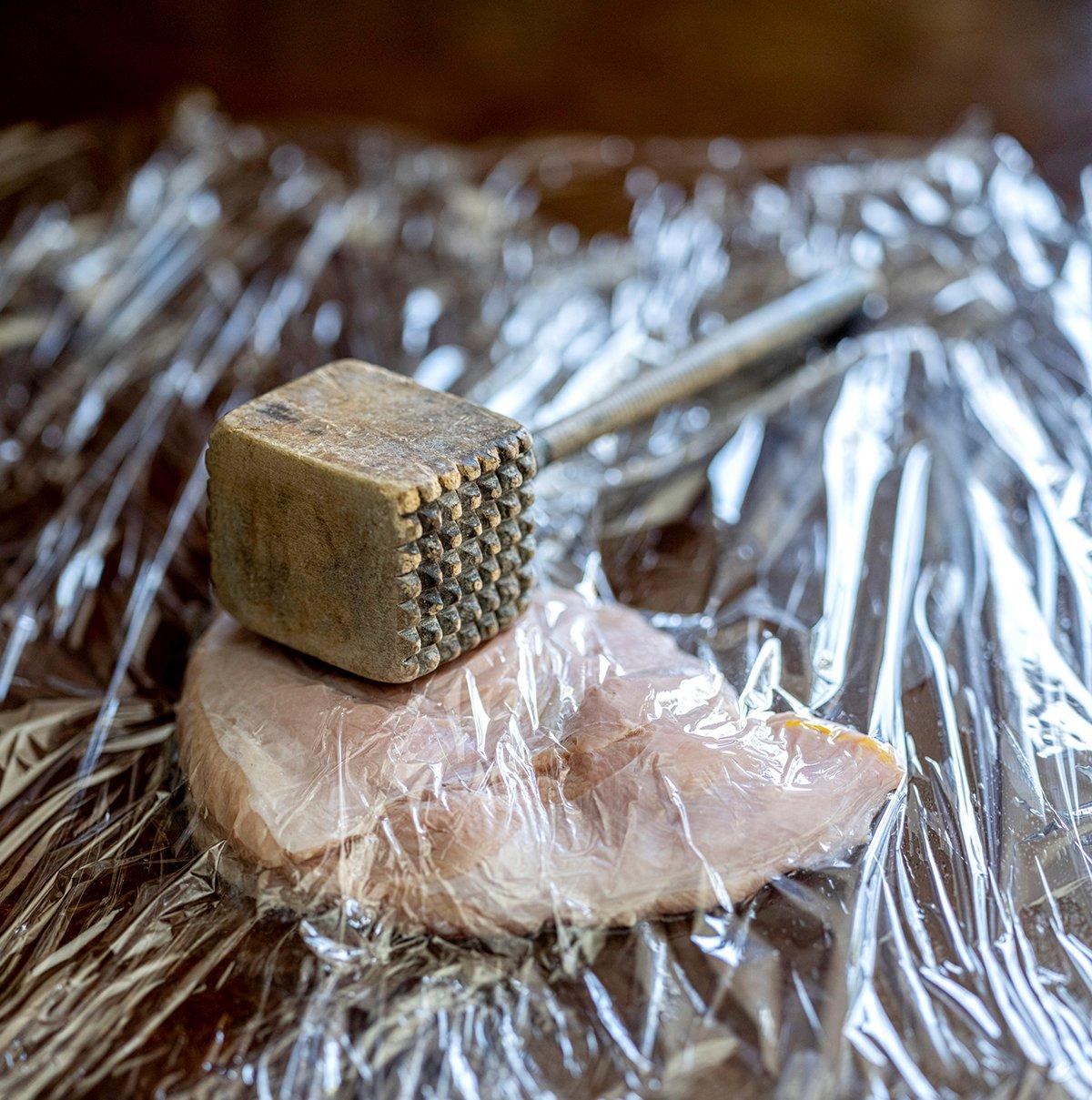 Pound the turkey breast flat with a meat mallet.