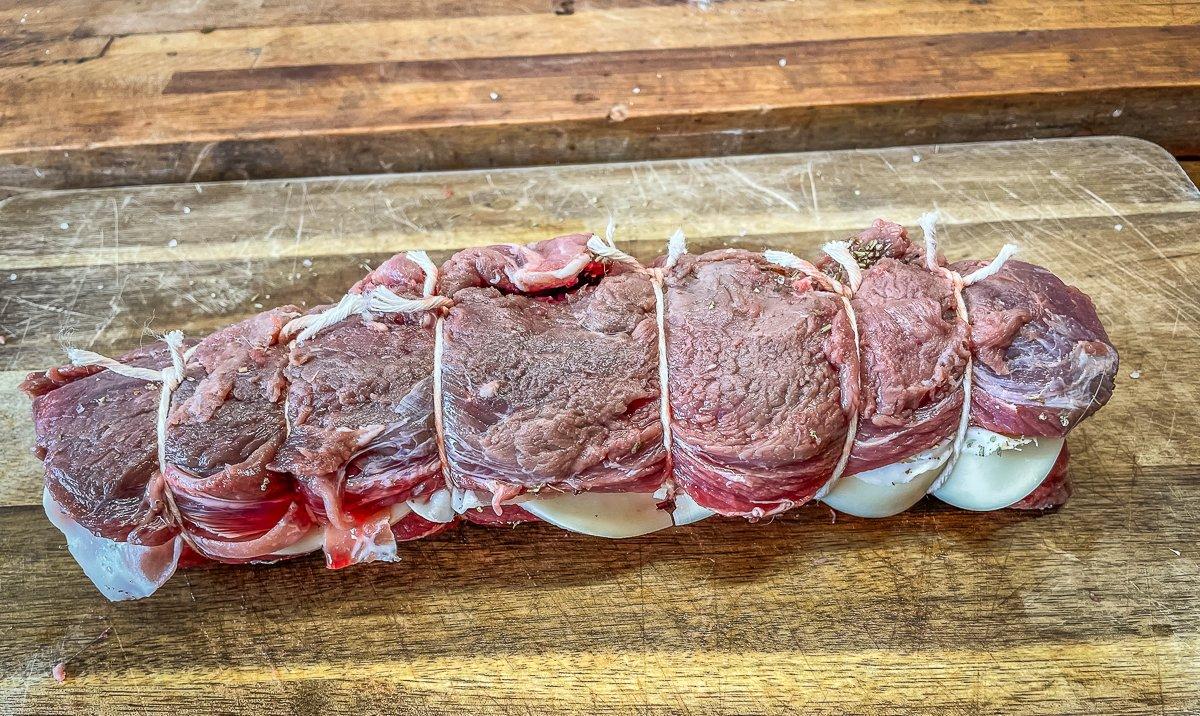 Roll the backstrap tightly and secure with butcher's twine.