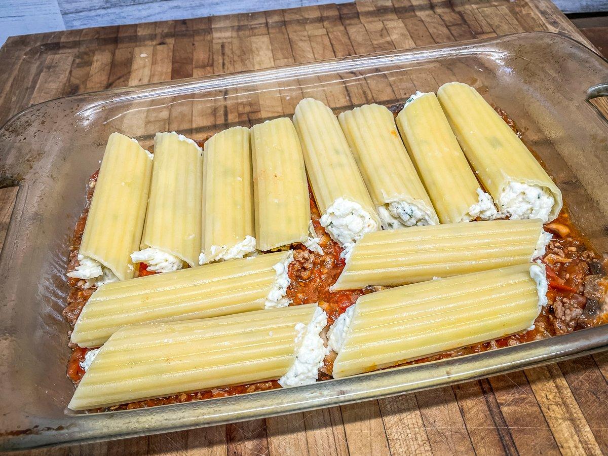 Spoon sauce into a baking dish, then add the cheese-filled pasta.