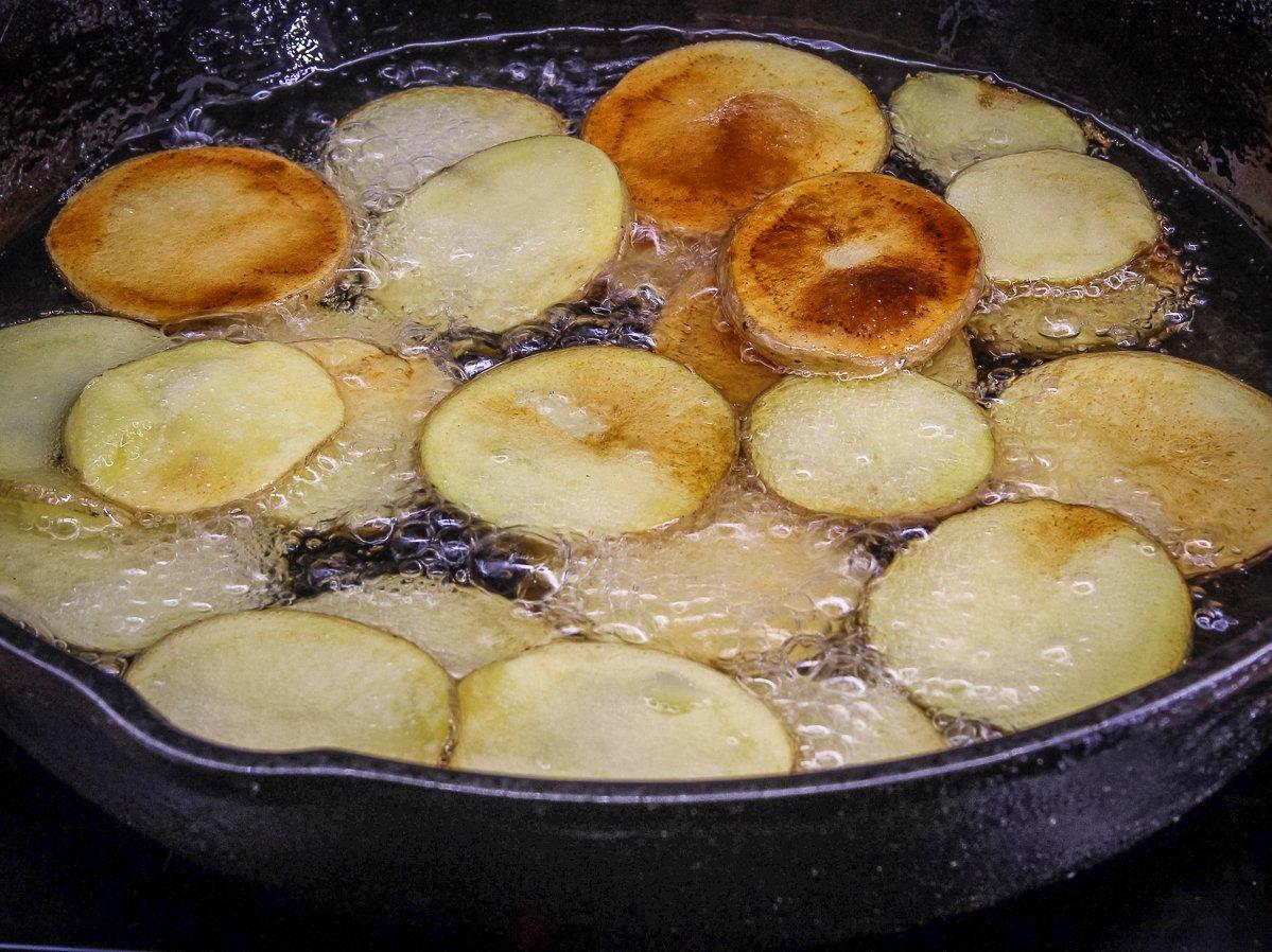 Fry the sliced potatoes in small batches for extra crispiness. 