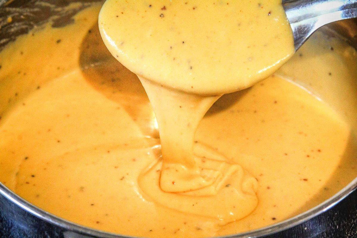 Stir the beer cheese sauce until it is smooth and creamy.