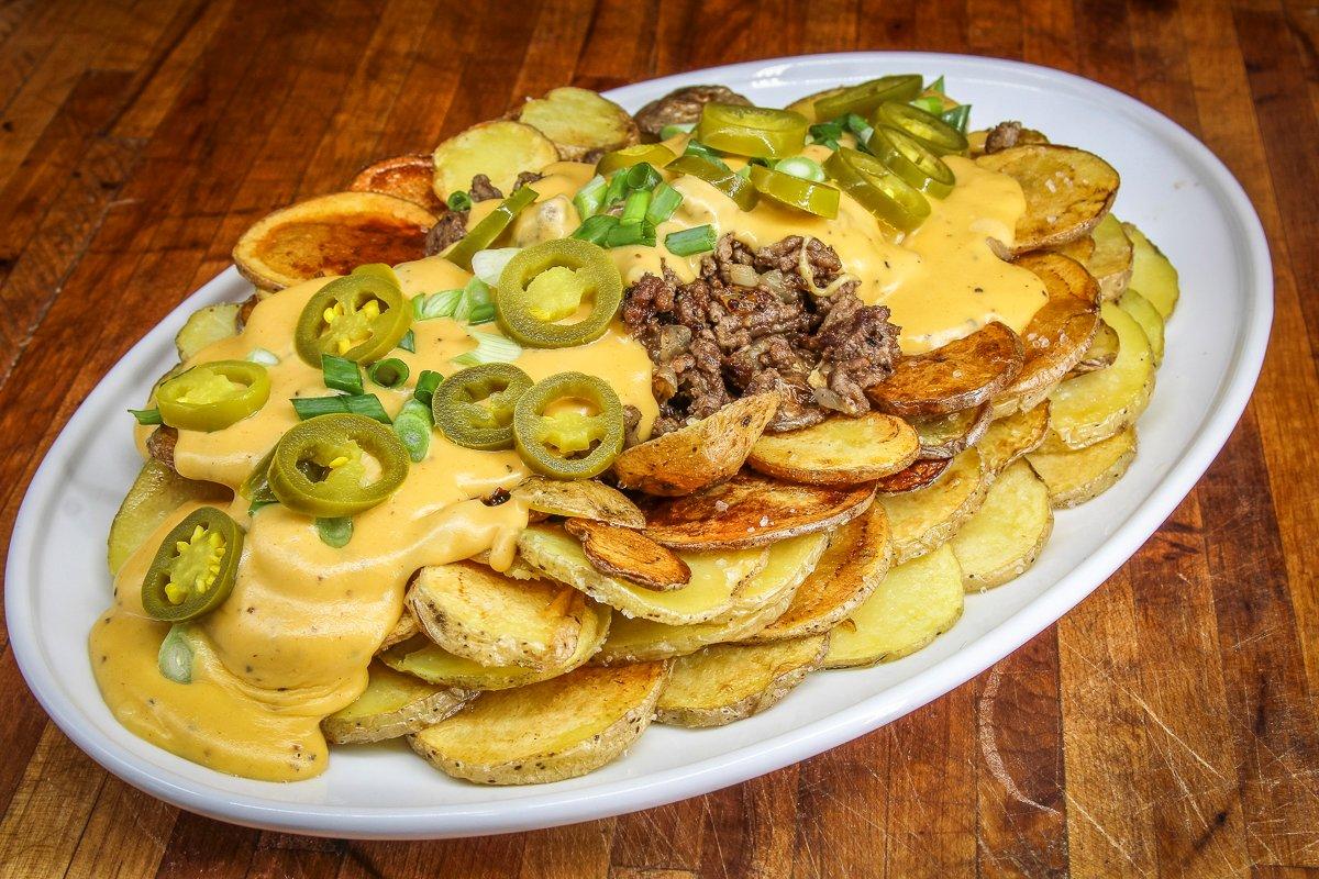 Form a shallow bowl with the potatoes, then fill it with venison and beer cheese sauce.