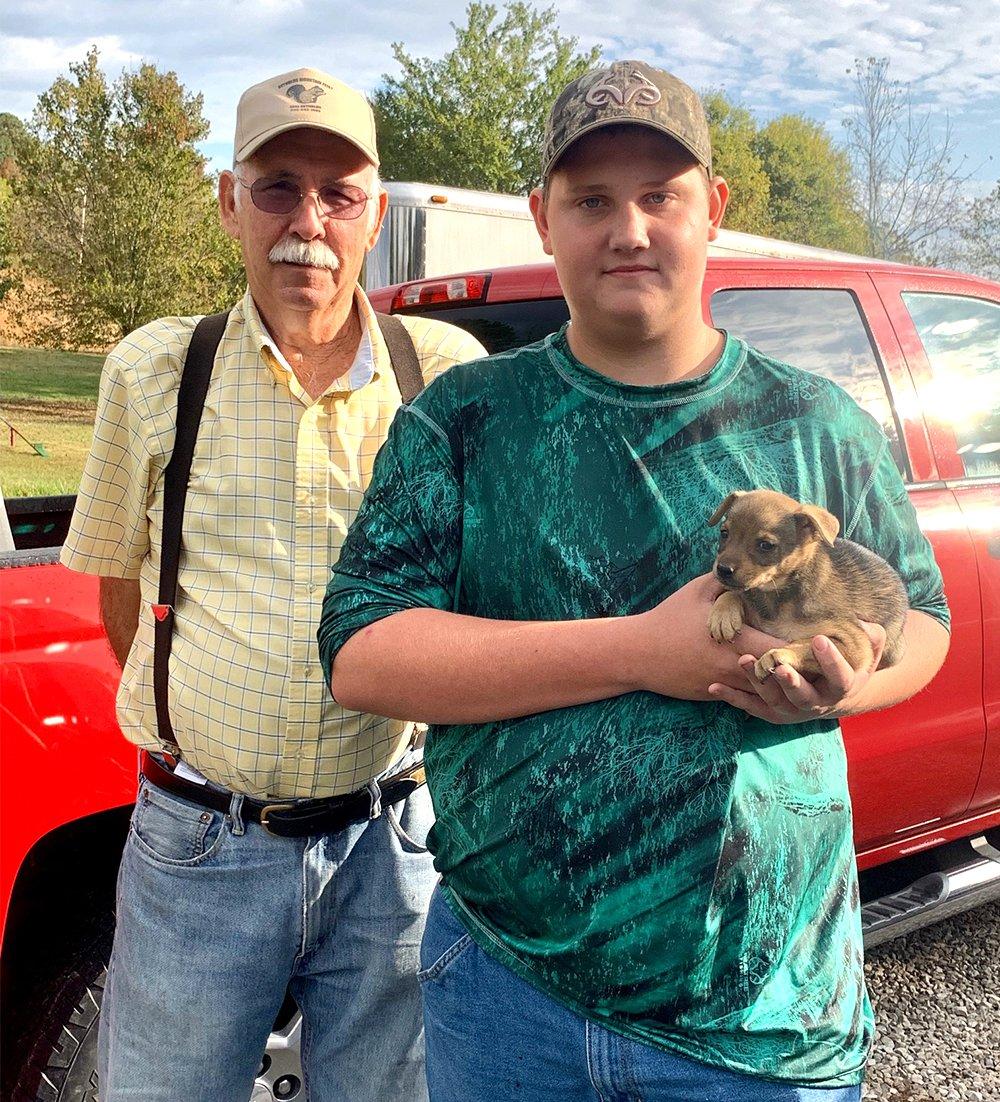 Earl Reynolds and Potroast Pendley with Potroast's new feist pup, Miss Ellie.