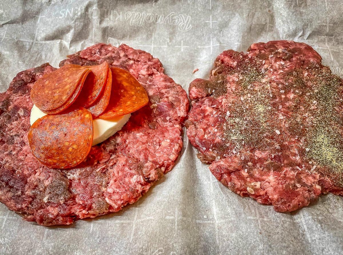 Form two thin patties, season, add the pepperoni and cheese, then seal together to form a stuffed burger.