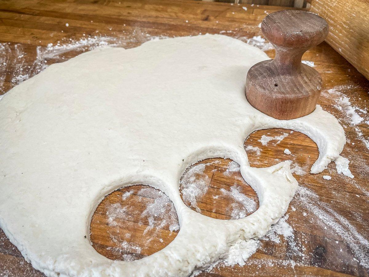 Roll the dough and use a glass or a biscuit cutter to cut out biscuits.