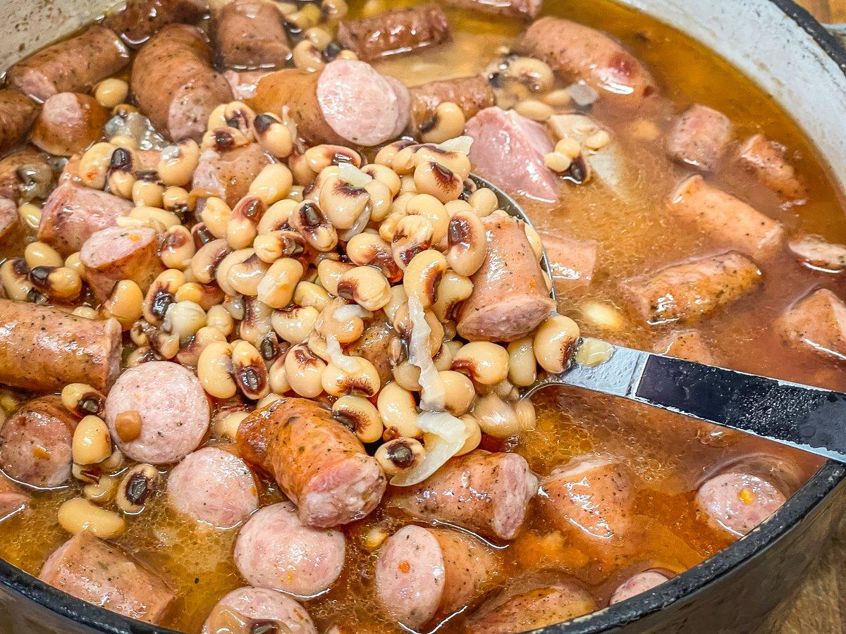 After adding the sausage to the cooked peas, simmer for another 15 to 30 minutes.