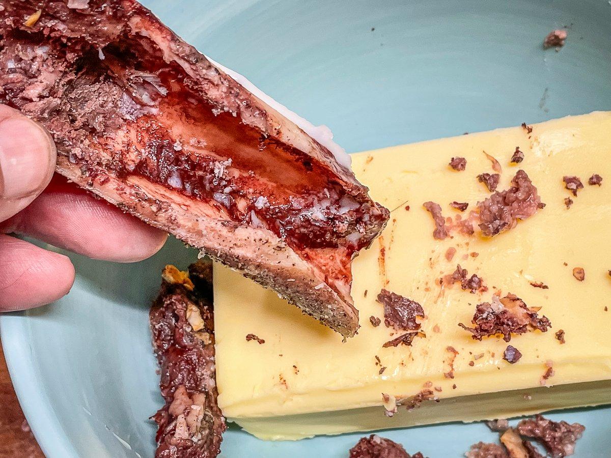 Scrape the grilled bone marrow into the softened butter.